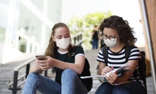 High school students in the new normal studying on stairway